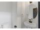 Cozy powder room features a round mirror, pedestal sink, and modern fixtures at 4517 Lime Straight Dr, Las Vegas, NV 89115