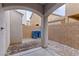 Small gravel side yard with block wall, concrete pad, and covered archway at 4517 Lime Straight Dr, Las Vegas, NV 89115