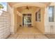 Covered patio area with ceiling fan and tiled flooring, offering a cool and relaxing outdoor space at 465 Indigo Springs St, Henderson, NV 89014