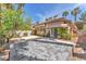 Lush backyard with a patio, palm trees, greenery, and privacy walls at 465 Indigo Springs St, Henderson, NV 89014