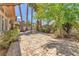 Backyard featuring a patio, desert landscaping, palm trees, and a garden at 465 Indigo Springs St, Henderson, NV 89014