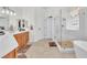 Modern bathroom with double vanities, a glass-enclosed shower, and a soaking tub at 465 Indigo Springs St, Henderson, NV 89014