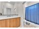 Bathroom with a single vanity, wooden cabinets, and a shower with a blue curtain at 465 Indigo Springs St, Henderson, NV 89014