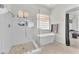 Bright bathroom with a glass-enclosed shower and a soaking tub at 465 Indigo Springs St, Henderson, NV 89014