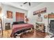 Cozy bedroom with a ceiling fan, hardwood floors, closet space, and curated decor at 465 Indigo Springs St, Henderson, NV 89014