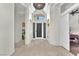 Inviting foyer featuring tiled floor, a decorative light fixture, and access to various rooms at 465 Indigo Springs St, Henderson, NV 89014