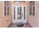 Close up of a front door with decorative glass, sidelights, and transom window providing ample natural light at 465 Indigo Springs St, Henderson, NV 89014