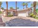Lovely single story home with a brick driveway, desert landscaping, and a two car garage at 465 Indigo Springs St, Henderson, NV 89014