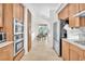 Well-equipped kitchen with wood cabinets, stainless steel appliances, and a view to the dining area at 465 Indigo Springs St, Henderson, NV 89014