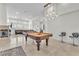 Open concept living room with a fireplace, comfortable seating, and a pool table at 465 Indigo Springs St, Henderson, NV 89014