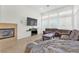 Bright living room featuring a fireplace, comfortable seating, and ample natural light at 465 Indigo Springs St, Henderson, NV 89014