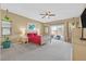 A spacious bedroom with a ceiling fan, outside patio access, carpet flooring and neutral paint at 5226 Lignum Ave # 1, Pahrump, NV 89061