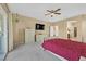 A Primary bedroom showcases a large TV, ensuite bathroom, plush carpet, and an outside view at 5226 Lignum Ave # 1, Pahrump, NV 89061