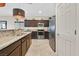 A kitchen features dark wood cabinets, granite countertops, stainless steel appliances, and tile flooring at 5226 Lignum Ave # 1, Pahrump, NV 89061