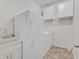 Functional laundry room with modern washer and dryer, utility sink, and ample storage at 5226 Lignum Ave # 1, Pahrump, NV 89061
