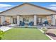 Large covered patio featuring stylish outdoor furniture and an artificial lawn at 5226 Lignum Ave # 1, Pahrump, NV 89061