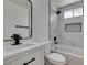 Modern bathroom featuring white-marble styled tile surround and black hardware at 5273 Manassas Ave, Las Vegas, NV 89122