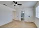 Bright bedroom with light-colored laminate flooring, ceiling fan, and three doors at 5273 Manassas Ave, Las Vegas, NV 89122