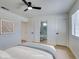 Bright bedroom with a ceiling fan, large windows, and ensuite bathroom at 5273 Manassas Ave, Las Vegas, NV 89122