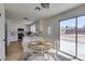 Bright dining area features a round table, stylish chandelier, and sliding glass door to the backyard at 5273 Manassas Ave, Las Vegas, NV 89122