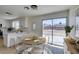 Bright dining area features a round table, stylish chandelier, and sliding glass door to the backyard at 5273 Manassas Ave, Las Vegas, NV 89122