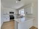 Modern kitchen features stainless steel appliances, white cabinets, and quartz countertops at 5273 Manassas Ave, Las Vegas, NV 89122