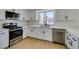 Modern kitchen features stainless steel appliances, white cabinets, and quartz countertops at 5273 Manassas Ave, Las Vegas, NV 89122