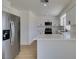 Modern kitchen with stainless steel appliances, white cabinets, and a spacious quartz countertop at 5273 Manassas Ave, Las Vegas, NV 89122