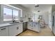 Modern kitchen with stainless steel appliances, white cabinets, and a view to the dining area at 5273 Manassas Ave, Las Vegas, NV 89122