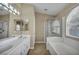 Well-appointed bathroom with a double vanity, a separate shower, and a soaking tub for ultimate relaxation at 544 Rancho Del Sol Way, North Las Vegas, NV 89031