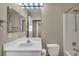 Bathroom featuring a white vanity and cabinets, a large mirror, and shower and toilet at 544 Rancho Del Sol Way, North Las Vegas, NV 89031