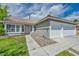 Inviting single-story home with a three-car garage and manicured front yard, showcasing a welcoming entrance at 544 Rancho Del Sol Way, North Las Vegas, NV 89031