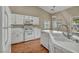 Bright kitchen with white appliances, countertops, and cabinets, offering a clean and functional cooking environment at 544 Rancho Del Sol Way, North Las Vegas, NV 89031