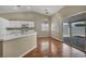 Well-lit kitchen with hardwood floors, white cabinets, and a sliding glass door, creating a bright and airy cooking space at 544 Rancho Del Sol Way, North Las Vegas, NV 89031