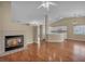Open-concept living room featuring a cozy fireplace and seamless flow into the adjacent kitchen area at 544 Rancho Del Sol Way, North Las Vegas, NV 89031