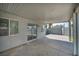 Covered patio features a concrete floor and string lights, offering a comfortable outdoor space for relaxation at 544 Rancho Del Sol Way, North Las Vegas, NV 89031