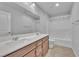 Bathroom featuring a double sink vanity with a large mirror and a shower at 5731 Sedona Springs St, North Las Vegas, NV 89031