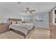 Cozy bedroom with wood flooring, a ceiling fan, and large windows providing a comfortable and well-lit space at 5731 Sedona Springs St, North Las Vegas, NV 89031