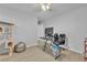 Bedroom area with a ceiling fan and an office setup with a large monitor at 5731 Sedona Springs St, North Las Vegas, NV 89031