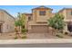 Two-story home featuring a well-manicured lawn, a brick driveway, and a 2-car garage at 5731 Sedona Springs St, North Las Vegas, NV 89031