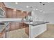 Modern kitchen with granite countertops, stainless steel appliances, and sleek brown cabinetry at 5731 Sedona Springs St, North Las Vegas, NV 89031