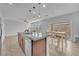 Open floor plan kitchen with island, stainless steel appliances and adjacent dining area at 5731 Sedona Springs St, North Las Vegas, NV 89031