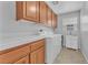 Laundry room with washer, dryer, and cabinet space, convenient for chores at 5731 Sedona Springs St, North Las Vegas, NV 89031
