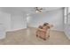 Open concept living space features light walls, tile floor, and a brown pattern chair at 5731 Sedona Springs St, North Las Vegas, NV 89031