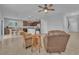 An open-concept living space with tile floors, a ceiling fan, and two sitting chairs at 5731 Sedona Springs St, North Las Vegas, NV 89031