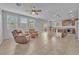 Open concept living space featuring a ceiling fan, a kitchen, and tile floors at 5731 Sedona Springs St, North Las Vegas, NV 89031