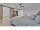 Comfortable main bedroom with wood floors, natural light, sliding barn door to the main bath, and a ceiling fan at 5731 Sedona Springs St, North Las Vegas, NV 89031