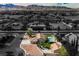 An aerial view of the property showcasing its layout, pool, landscaping, and the surrounding neighborhood at 5840 N El Capitan Way, Las Vegas, NV 89149