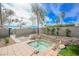 Private backyard featuring a spa, rock landscaping, and mature trees at 5840 N El Capitan Way, Las Vegas, NV 89149