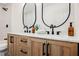 Bathroom with double wooden vanity, marble countertops, and black fixtures at 5840 N El Capitan Way, Las Vegas, NV 89149